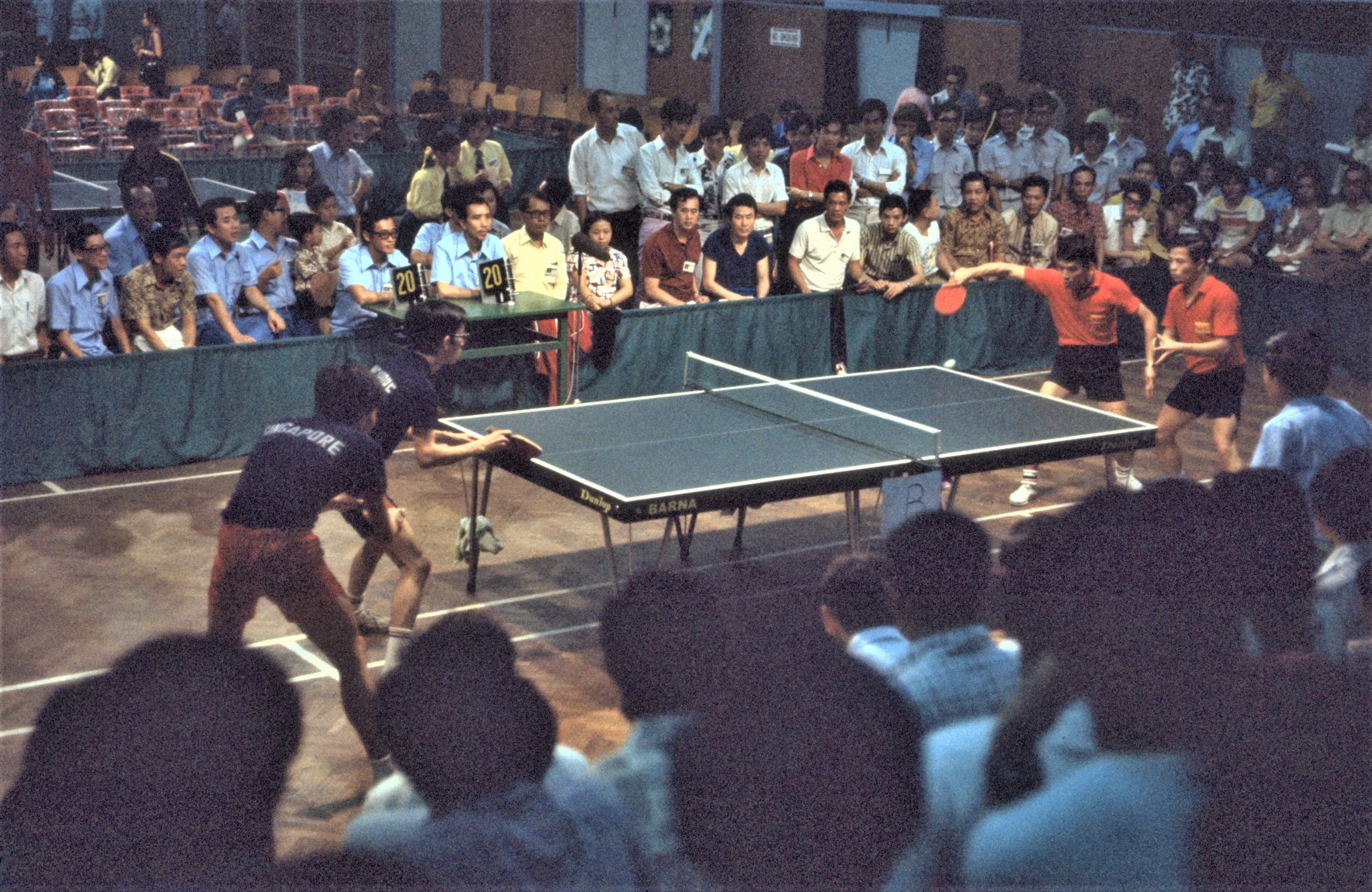 Singapore table tennis players Chia Choon Boon and Tan Yong Hong (left, in dark blue), 1973. Ministry of Information and the Arts Collection, courtesy of National Archives of Singapore.